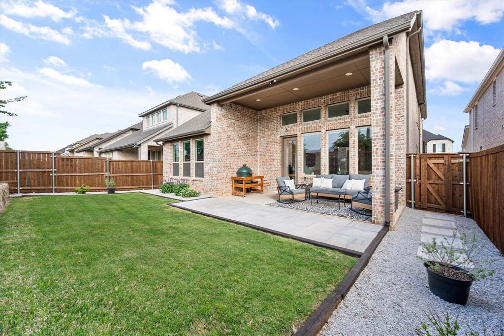 208 Scottish Way Mansfield, TX 76063 - Photo 32 of 38 Back of house with a fenced backyard, a gate, brick siding, a patio, and an outdoor lounge area!
