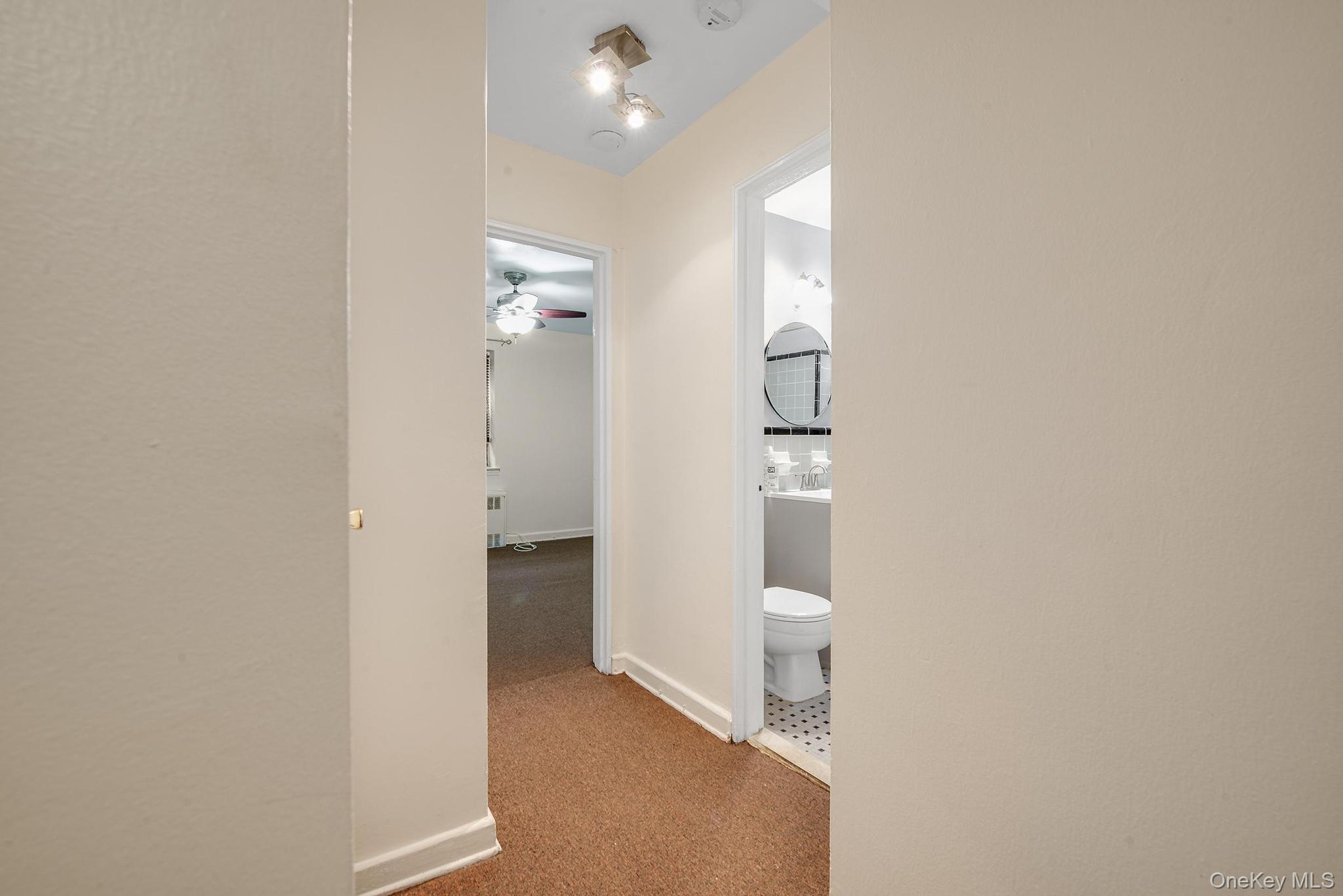102-25 67th Road, Unit 3C Queens, NY 11375 - Photo 12 of 17 Hallway with baseboards and light carpet