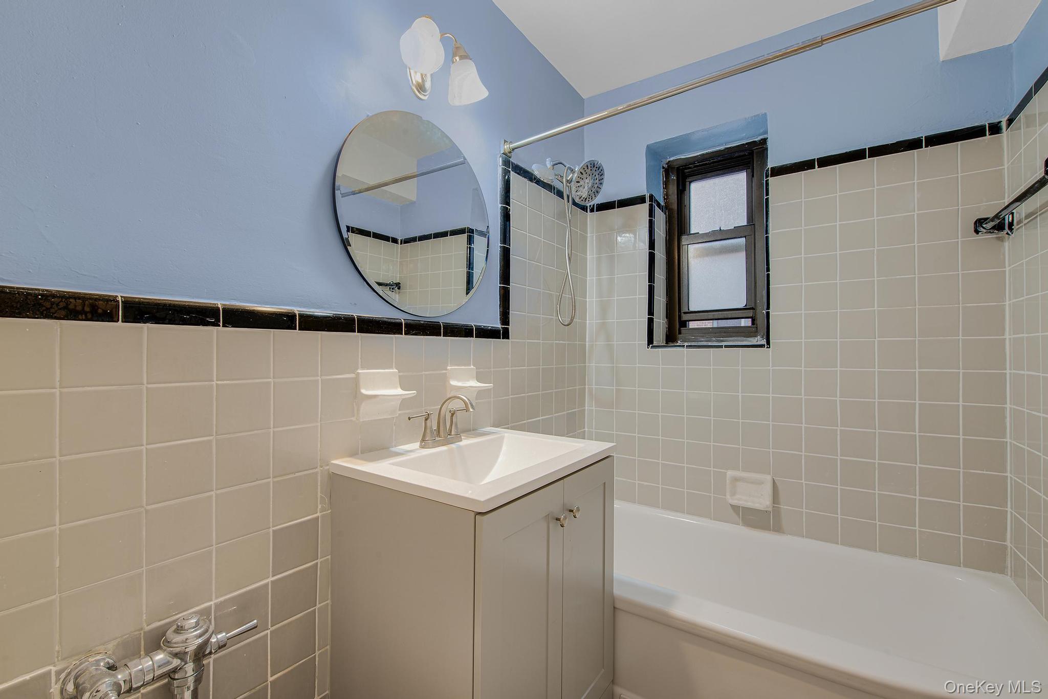 102-25 67th Road, Unit 3C Queens, NY 11375 - Photo 13 of 17 Full bathroom with bathtub / shower combination, tile walls, and vanity