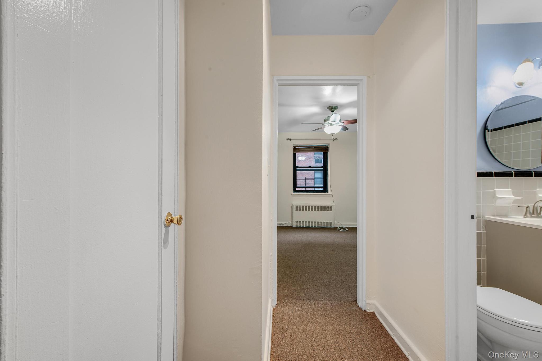 102-25 67th Road, Unit 3C Queens, NY 11375 - Photo 14 of 17 Corridor with carpet floors and radiator
