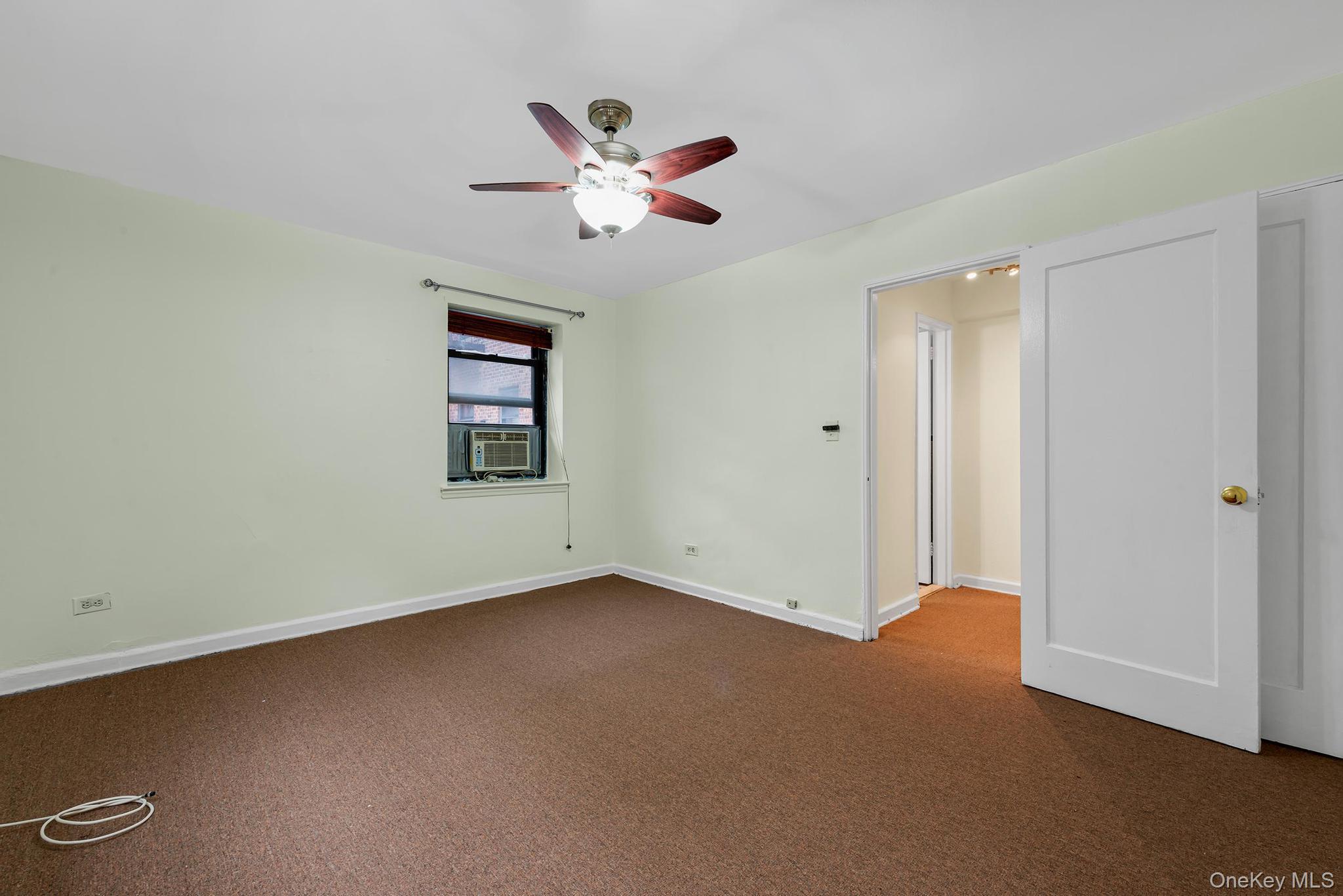 102-25 67th Road, Unit 3C Queens, NY 11375 - Photo 15 of 17 Unfurnished bedroom with dark colored carpet and ceiling fan