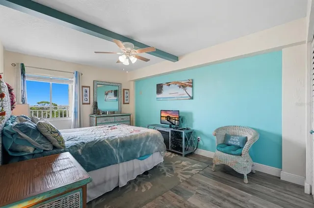 a bedroom with a bed couch and a window