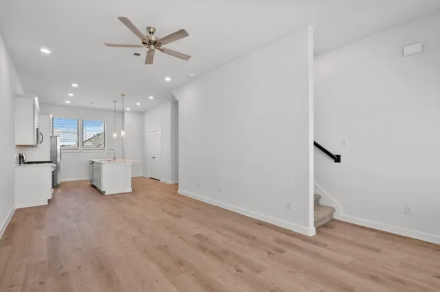 a view of an empty room with a kitchen