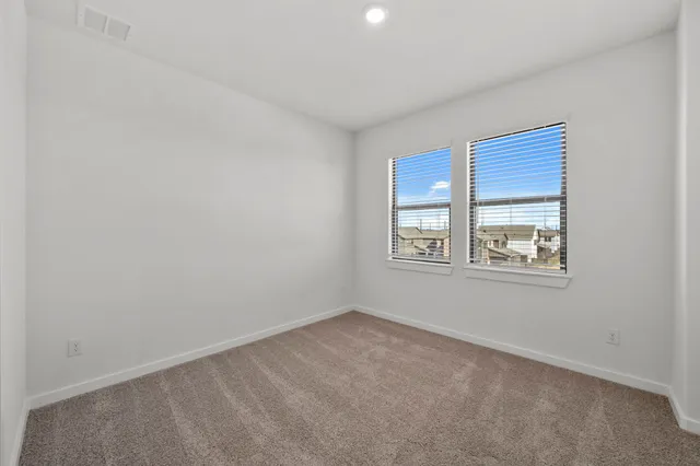 an empty room with windows and closet