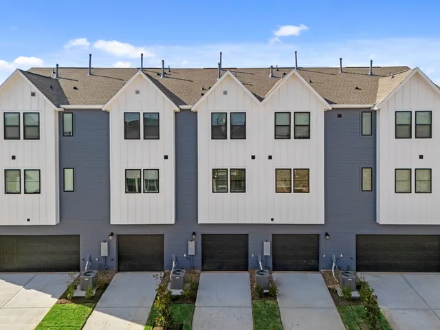 a view of a white house with a yard