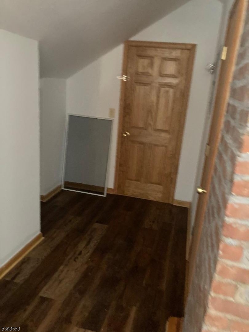 9 Orchard Street Passaic, NJ 07055 - Photo 13 of 19 an empty room with wooden floor and entrance