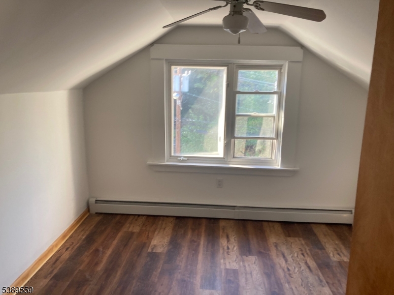 9 Orchard Street Passaic, NJ 07055 - Photo 16 of 19 a view of a room with window a ceiling fan and wooden floor