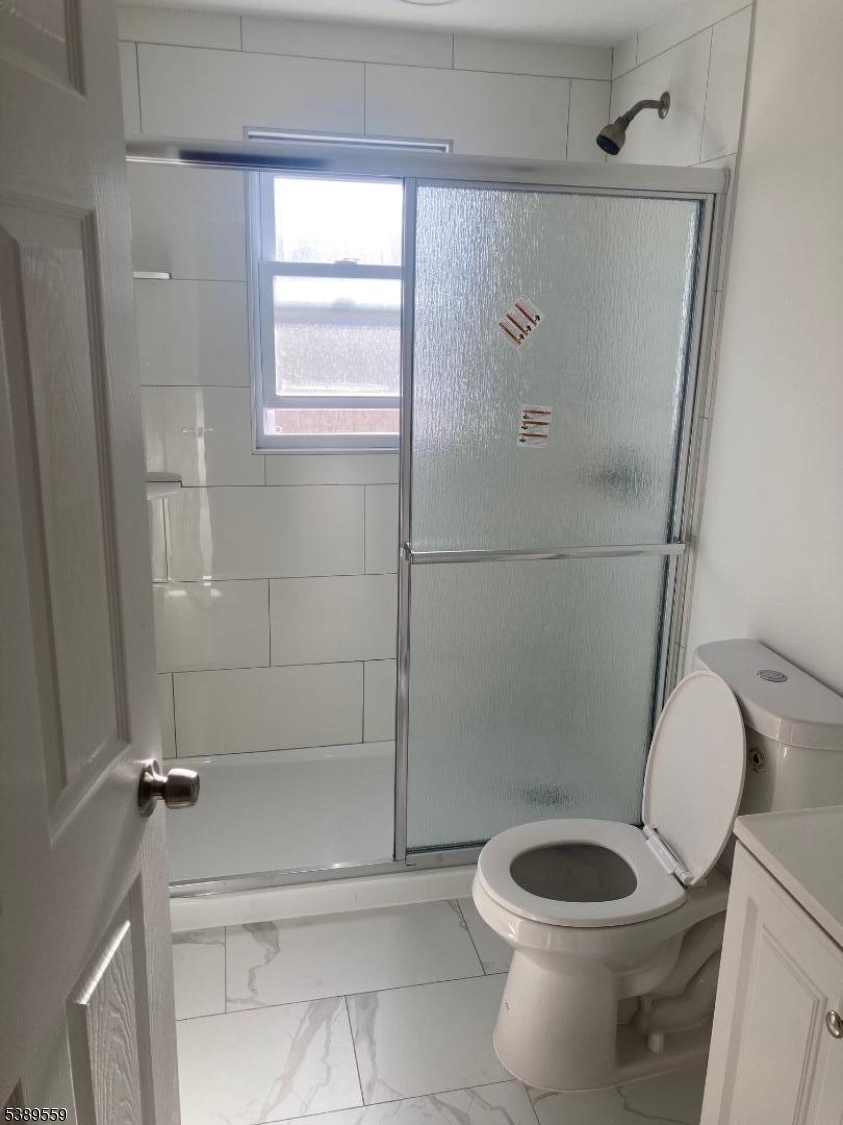 9 Orchard Street Passaic, NJ 07055 - Photo 10 of 19 a bathroom with a toilet and a shower