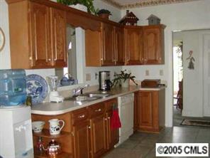 9837 Fairway Ridge Road Charlotte, NC 28277 - Photo 3 of 8 a kitchen with stainless steel appliances granite countertop a sink a stove and a refrigerator