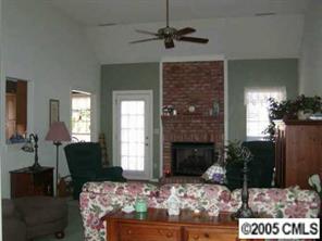 9837 Fairway Ridge Road Charlotte, NC 28277 - Photo 7 of 8 a living room with furniture windows and a fireplace