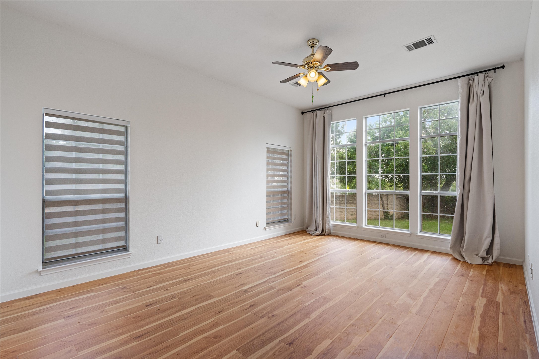 100 Parque Circle Georgetown, TX 78626 - Photo 18 of 39 a view of an empty room with a window and wooden floor