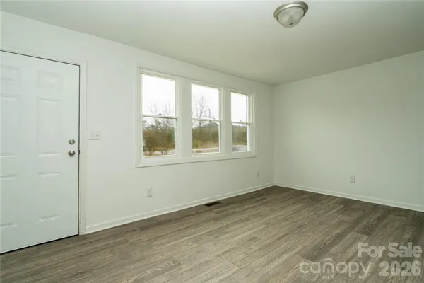 a kitchen with cabinets stainless steel appliances and a window