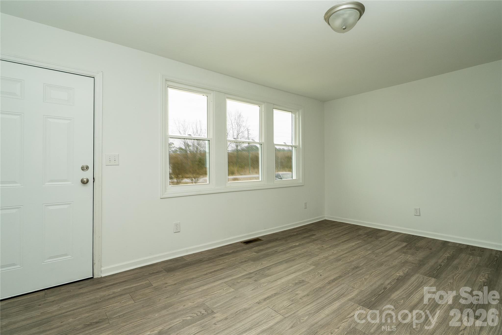 421 Pineville Road Darlington, SC 29532 - Photo 12 of 36 an empty room with wooden floor and windows