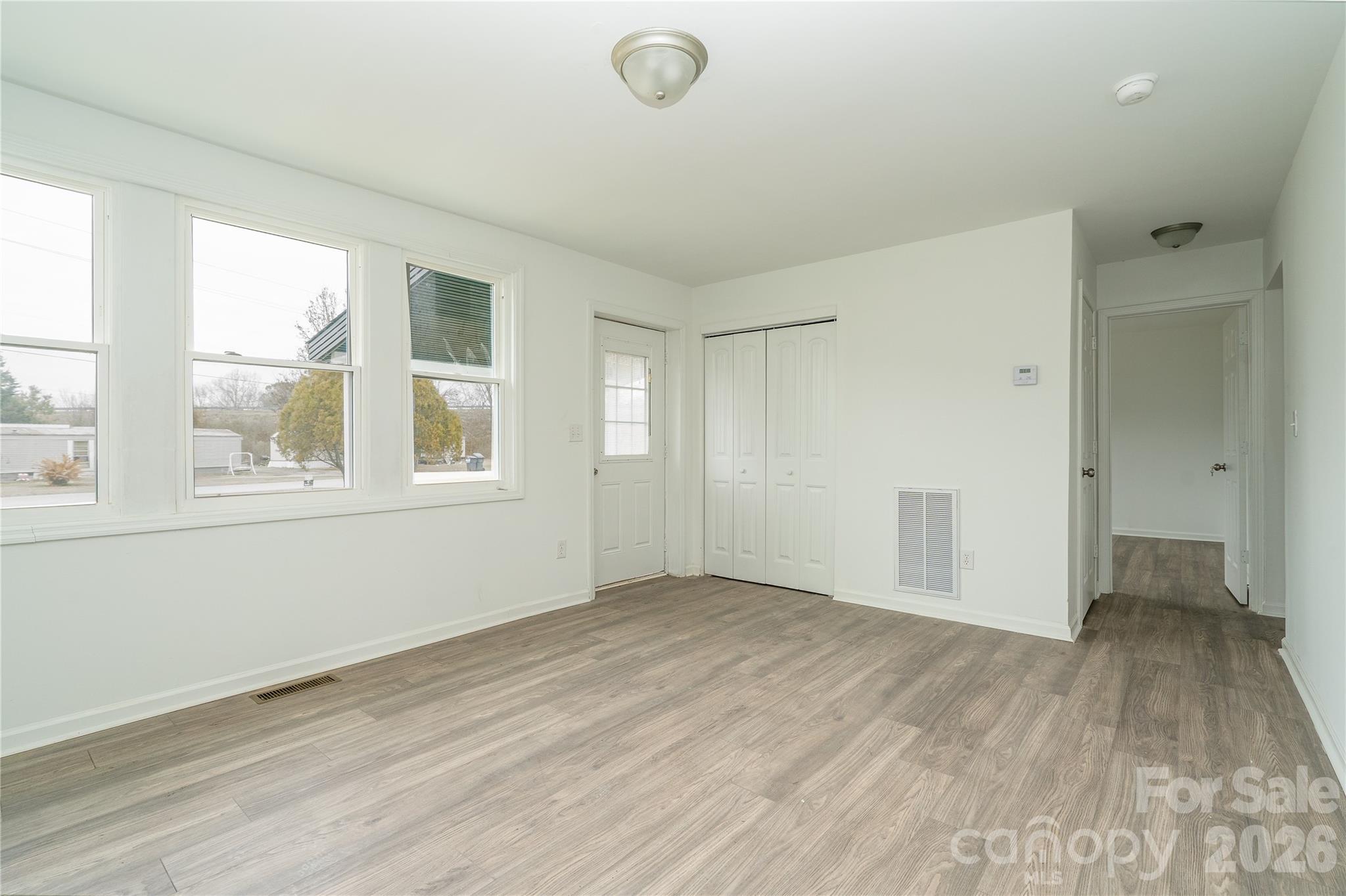 421 Pineville Road Darlington, SC 29532 - Photo 23 of 36 a view of an empty room with wooden floor and a window