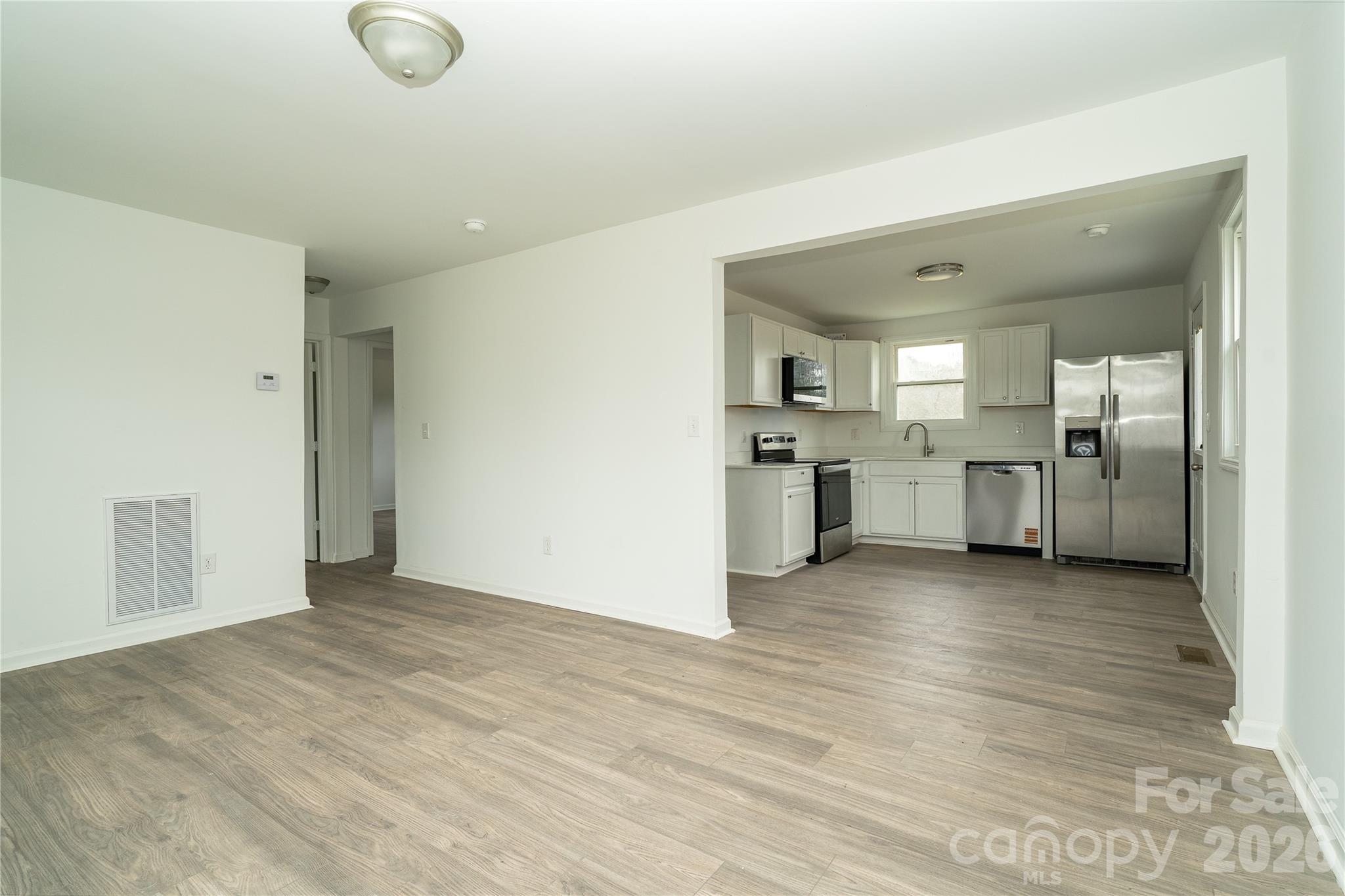 421 Pineville Road Darlington, SC 29532 - Photo 24 of 36 an empty room with stainless steel appliances kitchen island furniture and wooden floor