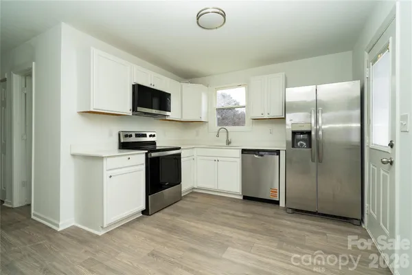 a kitchen with a refrigerator and a sink
