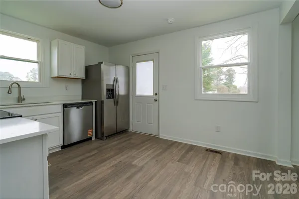 a kitchen with stainless steel appliances granite countertop a refrigerator and a sink