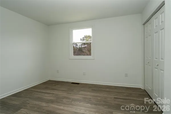 an empty room with wooden floor