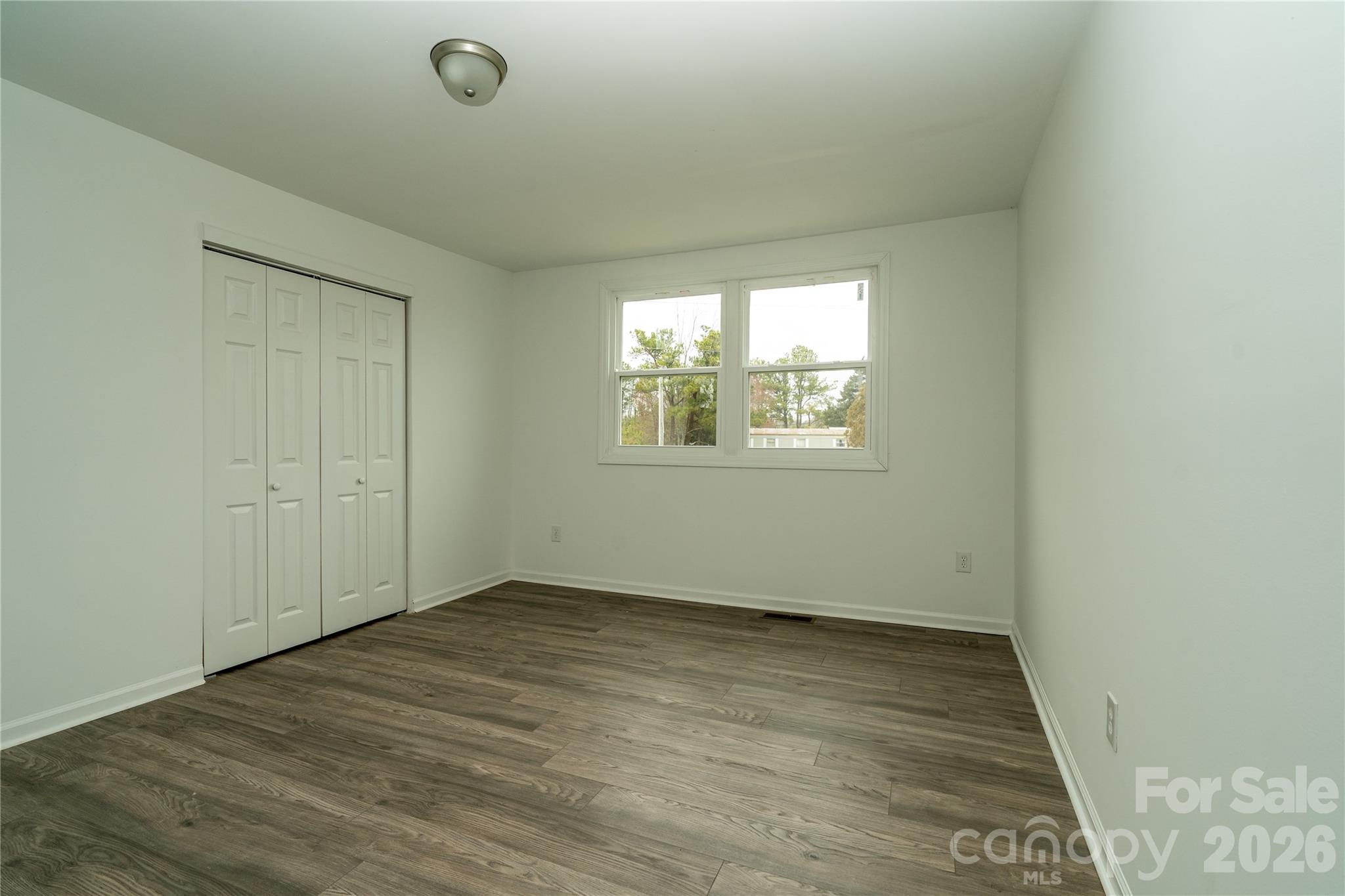 421 Pineville Road Darlington, SC 29532 - Photo 33 of 36 an empty room with wooden floor and windows