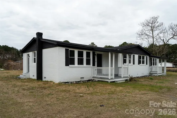 a view of a house with trees in the background