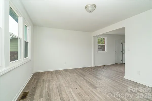 a view of a kitchen with a sink and a refrigerator