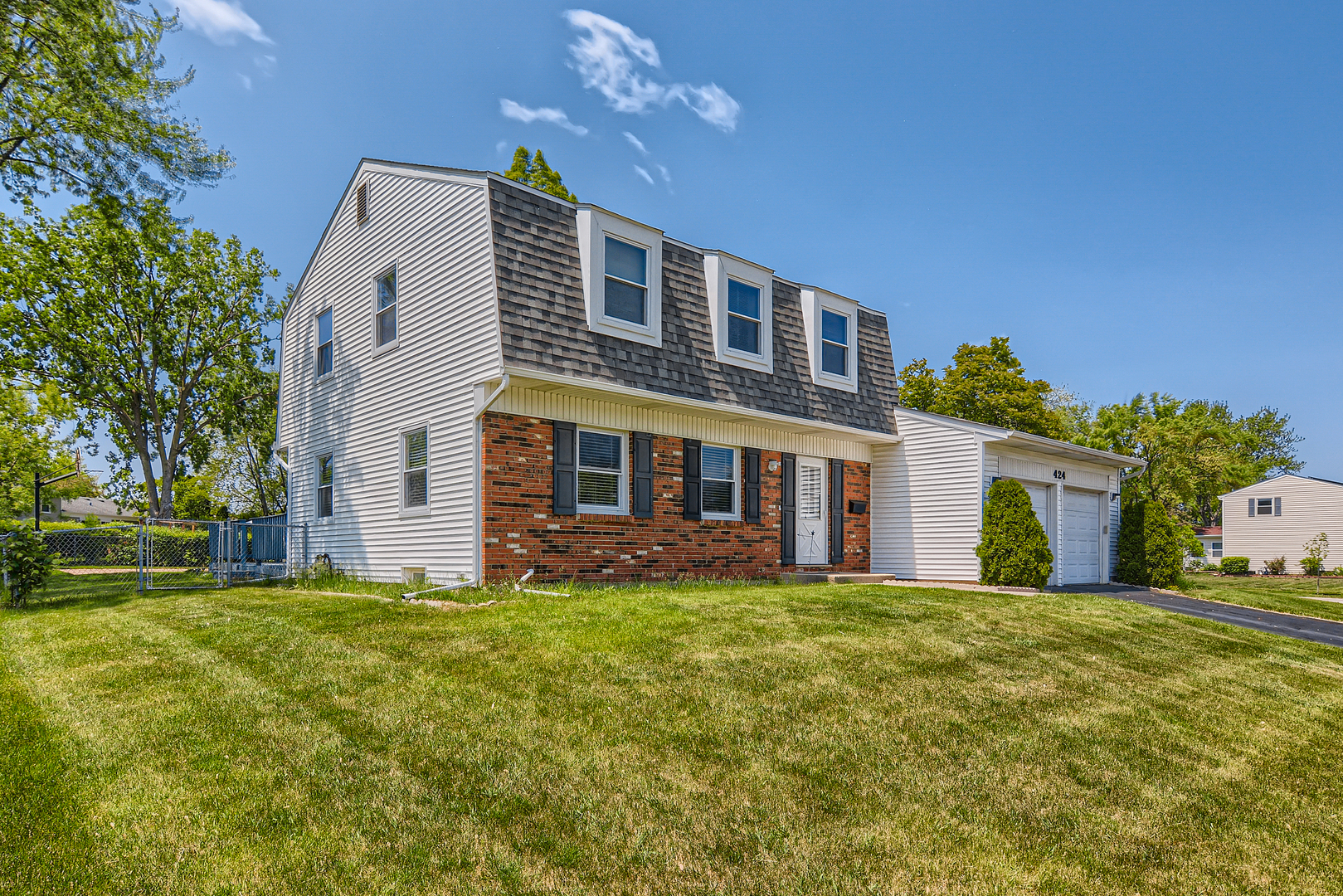 a view of a house with a yard and pathway