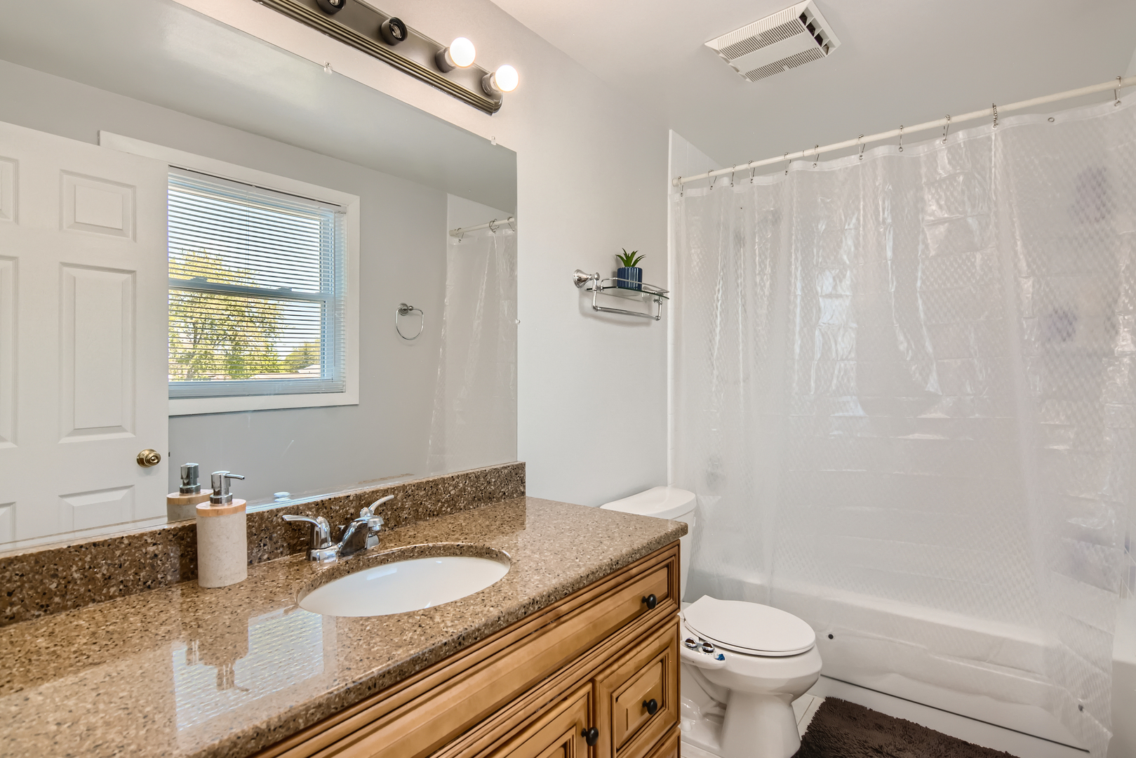 424 North Salem Drive Schaumburg, IL 60169 - Photo 22 of 26 a bathroom with a granite countertop sink toilet a mirror and shower