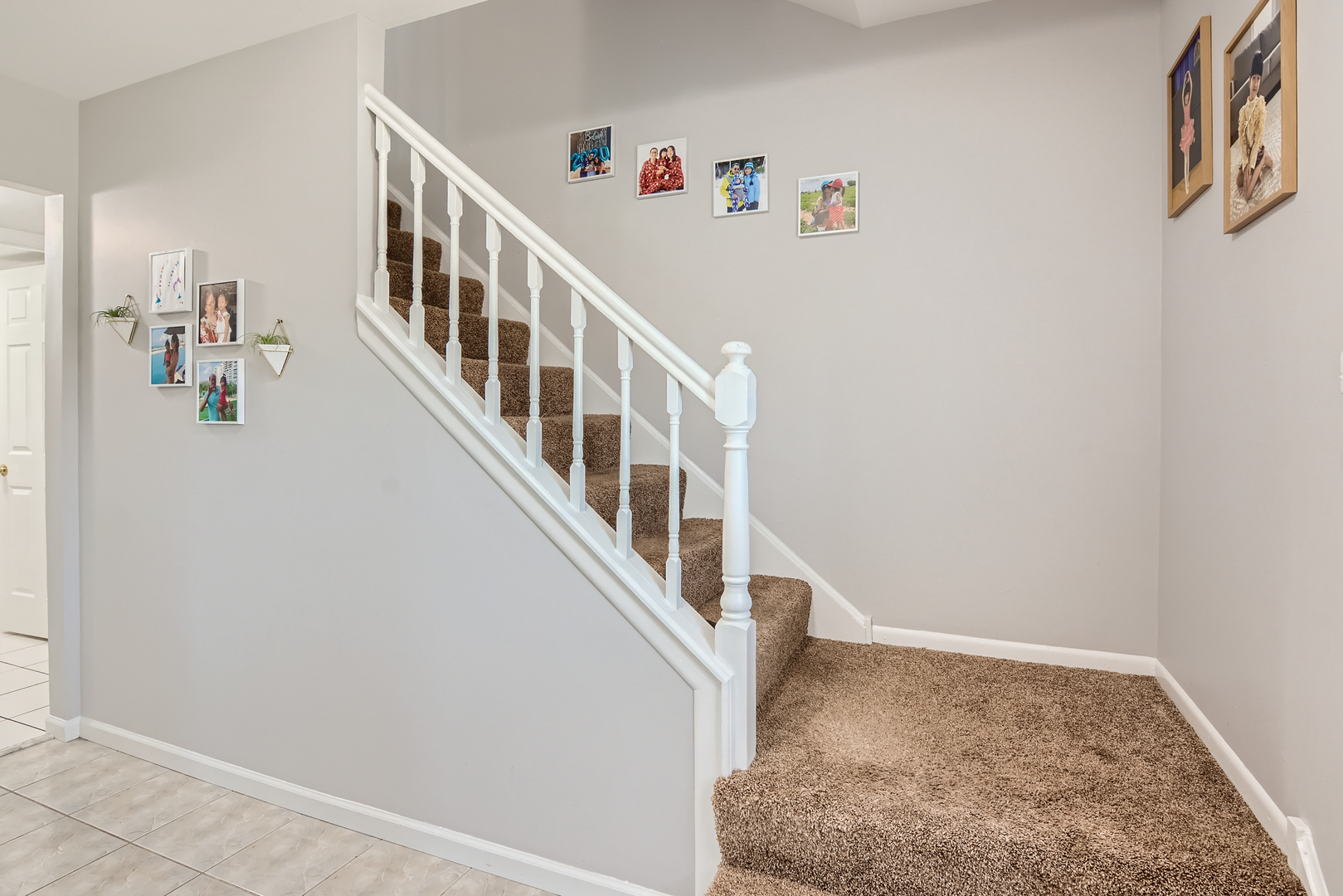 424 North Salem Drive Schaumburg, IL 60169 - Photo 4 of 26 a view of staircase with lots of frames on wall and a rug