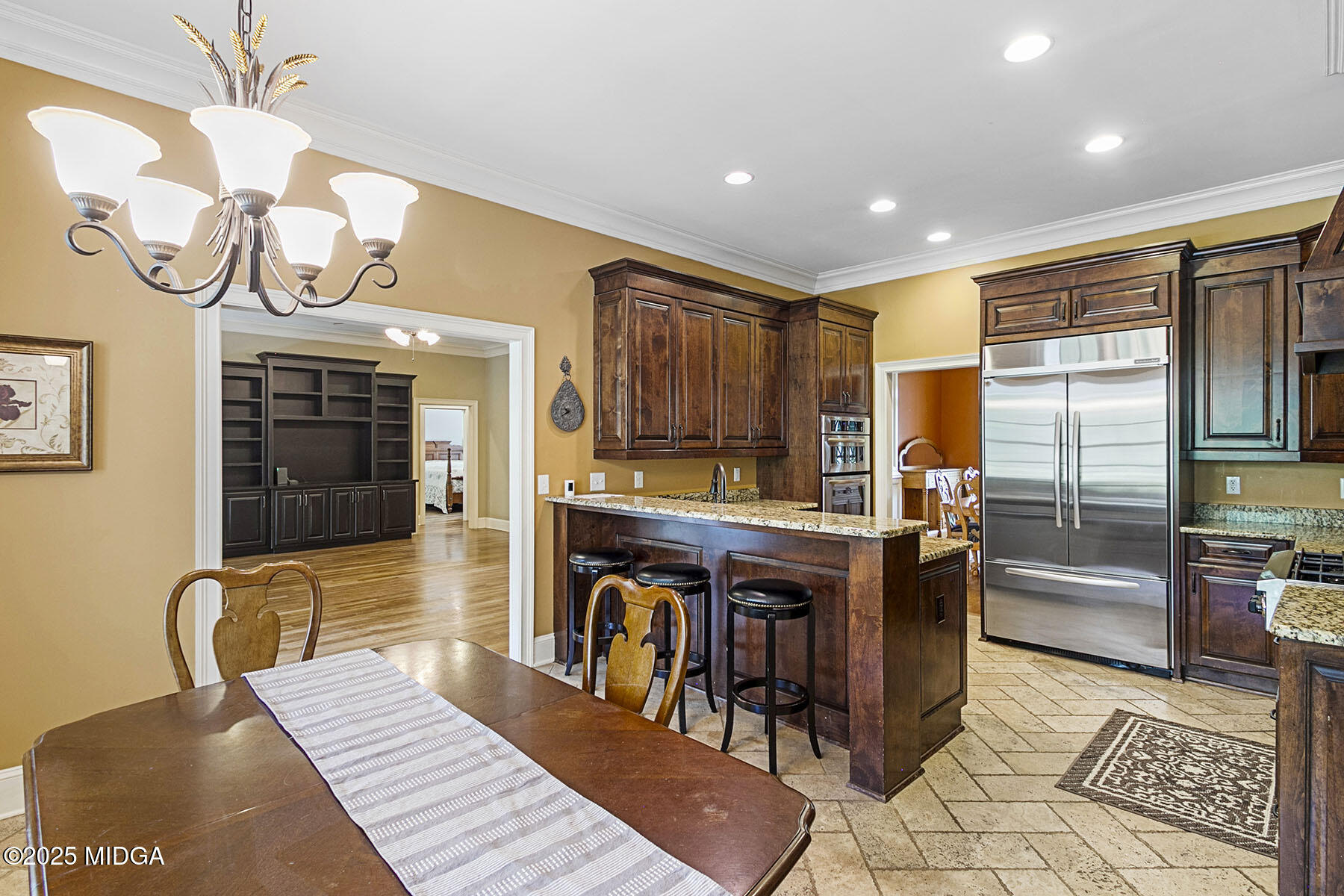 532 King Road Forsyth, GA 31029 - Photo 12 of 47 a kitchen with stainless steel appliances granite countertop a stove a refrigerator a oven a dining table and chairs with wooden floor