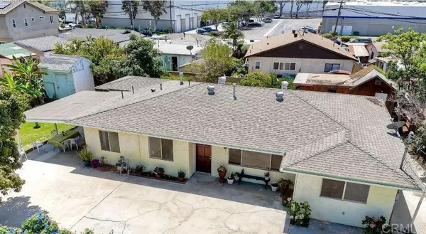 an aerial view of a house with a yard
