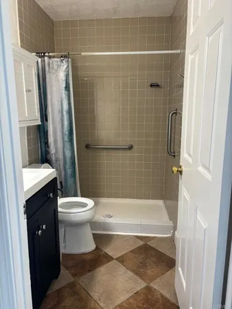 a bathroom with a shower and a toilet