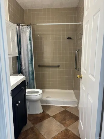 a bathroom with a shower and a toilet