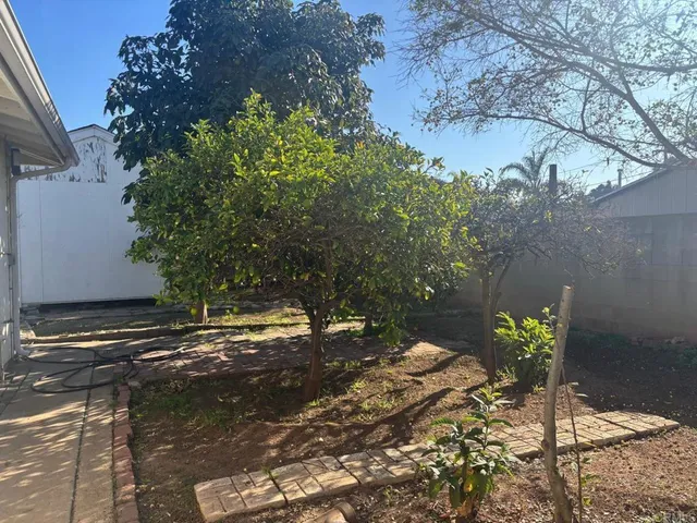 a view of a patio with table and chairs and potted plants