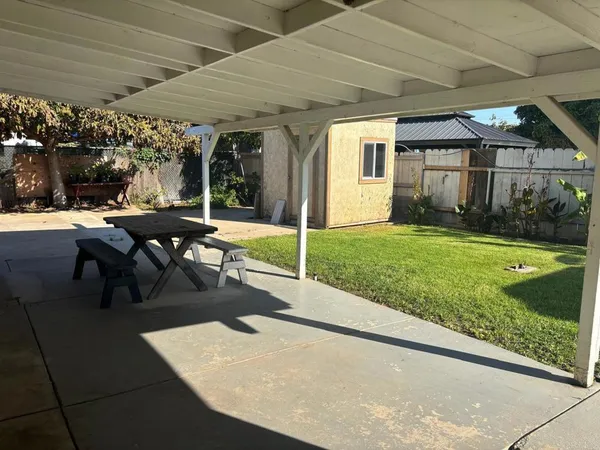 a view of a patio with a table and chairs