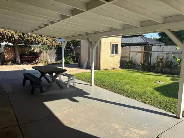 a view of a patio with a table and chairs