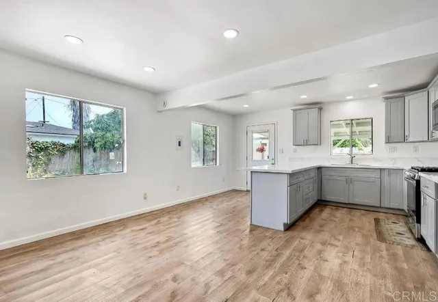 a kitchen with a wooden floor and window