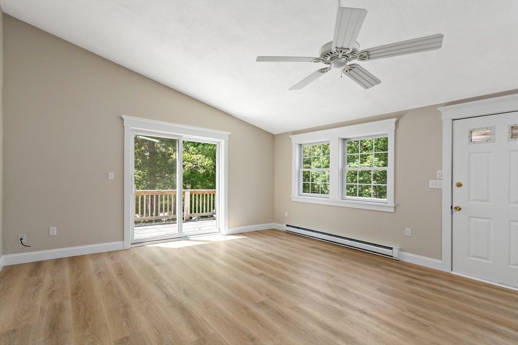 35 Ashumet Road, Unit 16C Mashpee, MA 02649 - Photo 7 of 21 a view of an empty room with a window and wooden floor
