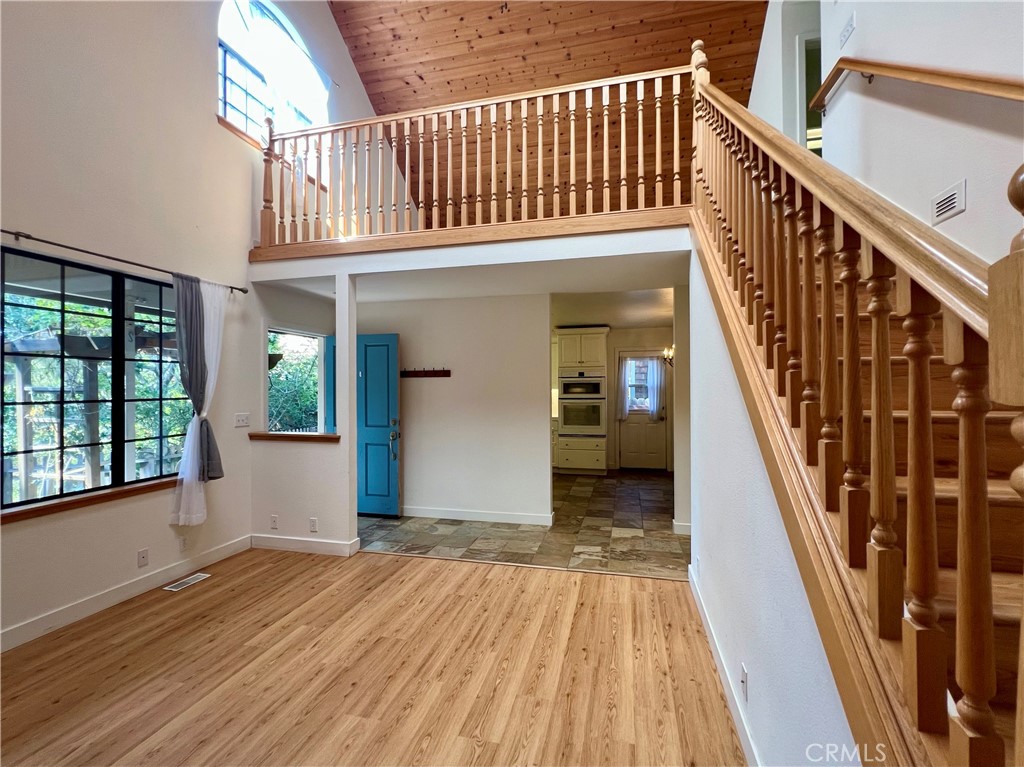 1530 Emerson Road Cambria, CA 93428 - Photo 11 of 54 Looking back towards front door and kitchen/ dining room. Stairs on right go up to the loft