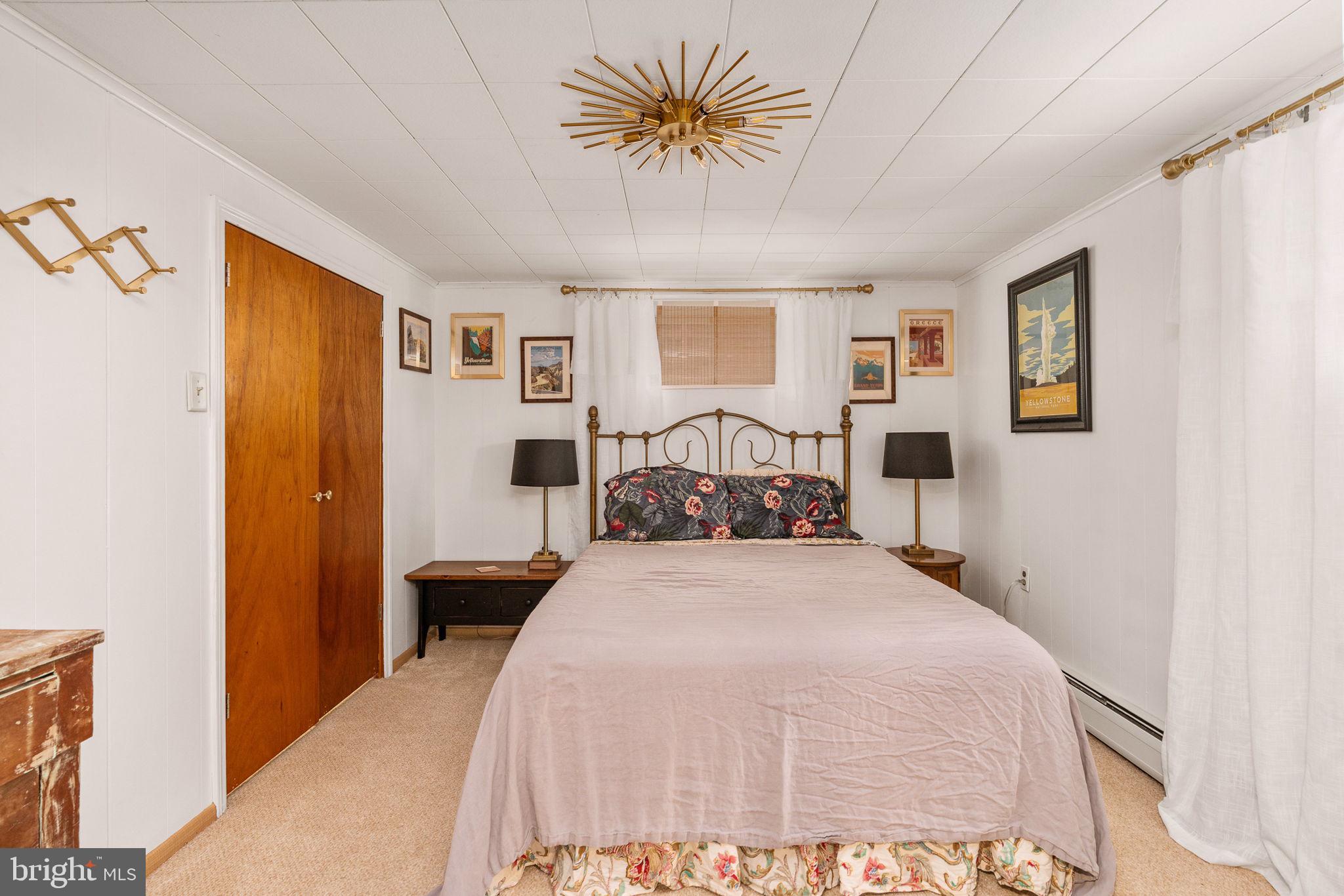 6714 Ruskin Street Springfield, VA 22150 - Photo 45 of 63 a bedroom with a bed and a chandelier