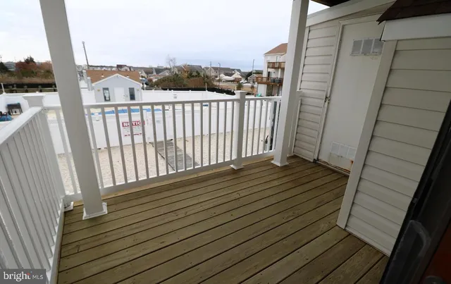 a view of a balcony with wooden floor