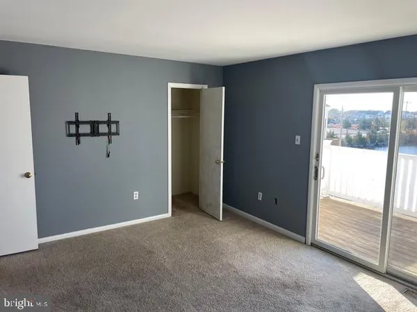 an empty room with windows and closet