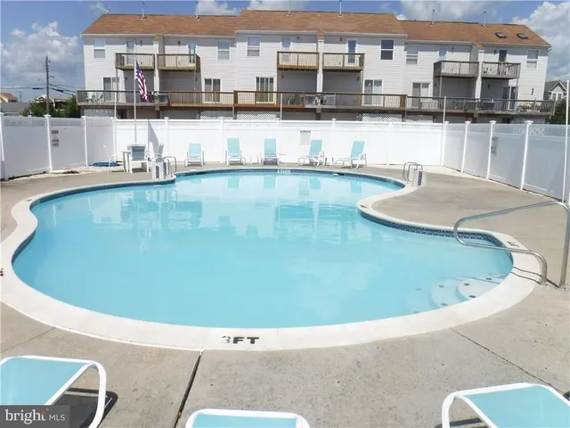 a view of a swimming pool with outdoor seating