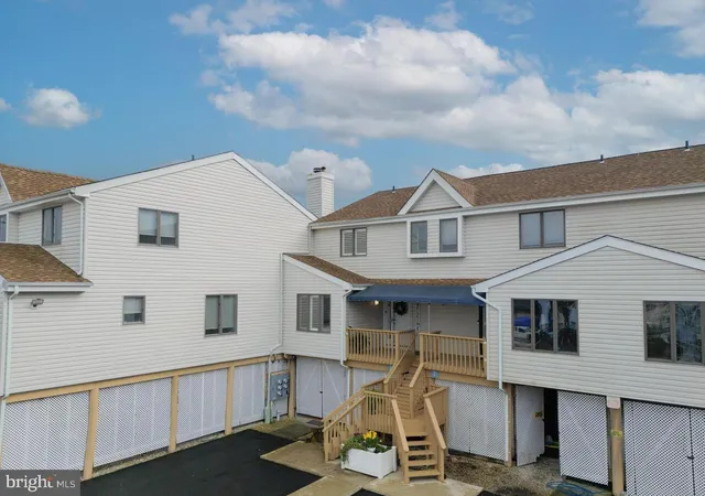 a view of a white house with iron fence