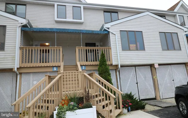 a view of wooden house and deck