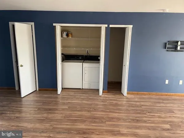 a view of hallway with wooden floor