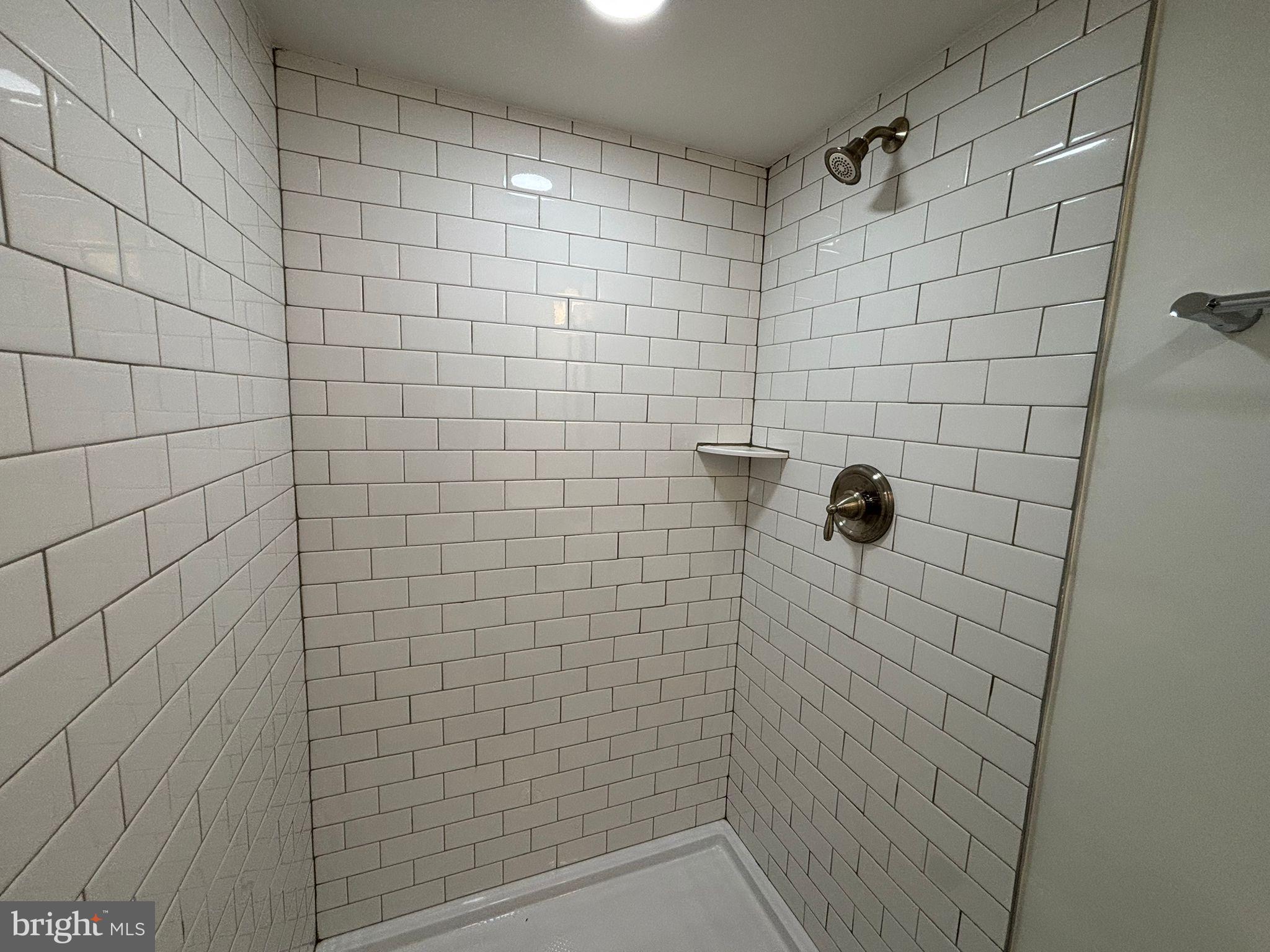 438 Lawrence Street Burlington, NJ 08016 - Photo 7 of 21 Sleek, modern shower with classic tile design.