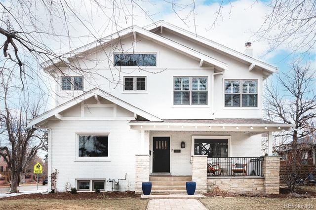 a view of a white house with large windows