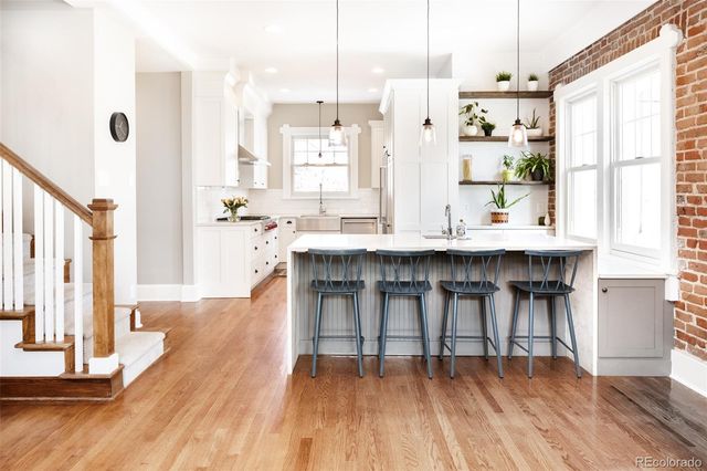 a open kitchen with stainless steel appliances granite countertop a stove and refrigerator