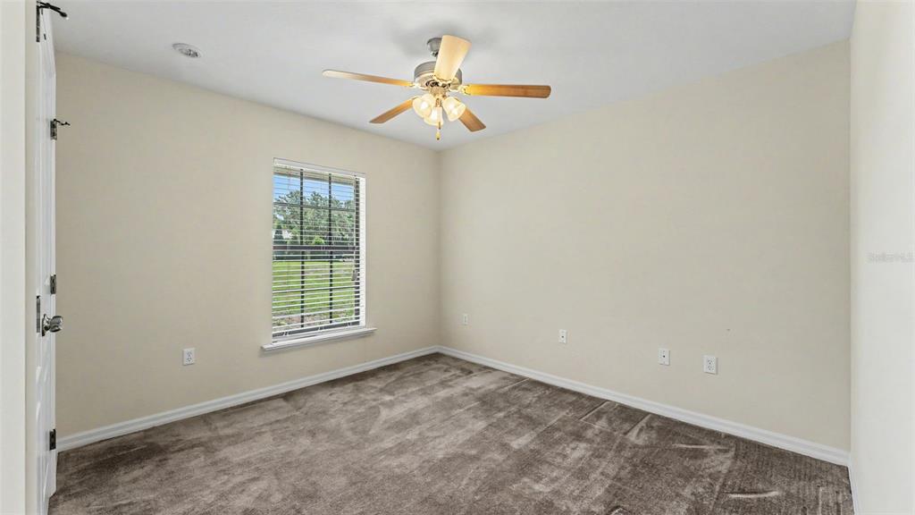 8525 North Campbell Road Lakeland, FL 33810 - Photo 13 of 45 an empty room with a window and a chandelier fan