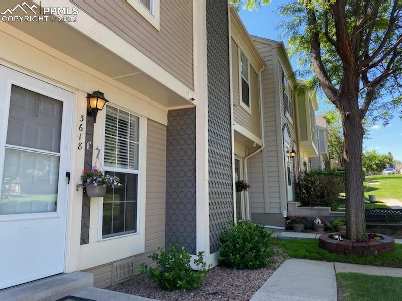 3618 Queen Anne Way Colorado Springs, CO 80917 - Photo 1 of 3 a front view of a house with a yard